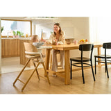 Scaun de masa multifunctional Celia, Lionelo, Din lemn de fag, 6 luni- adult, Reglabil pe inaltime, Spatar lat, Sezut ergonomic, Tavita silicon, Suport de picioare reglabil, Greutate maxima 90 Kg, Alb/Natural